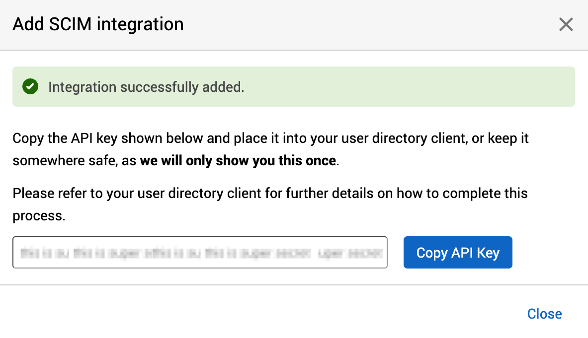 Integration successfully added message and API key shown in the Add SCIM integration dialog.